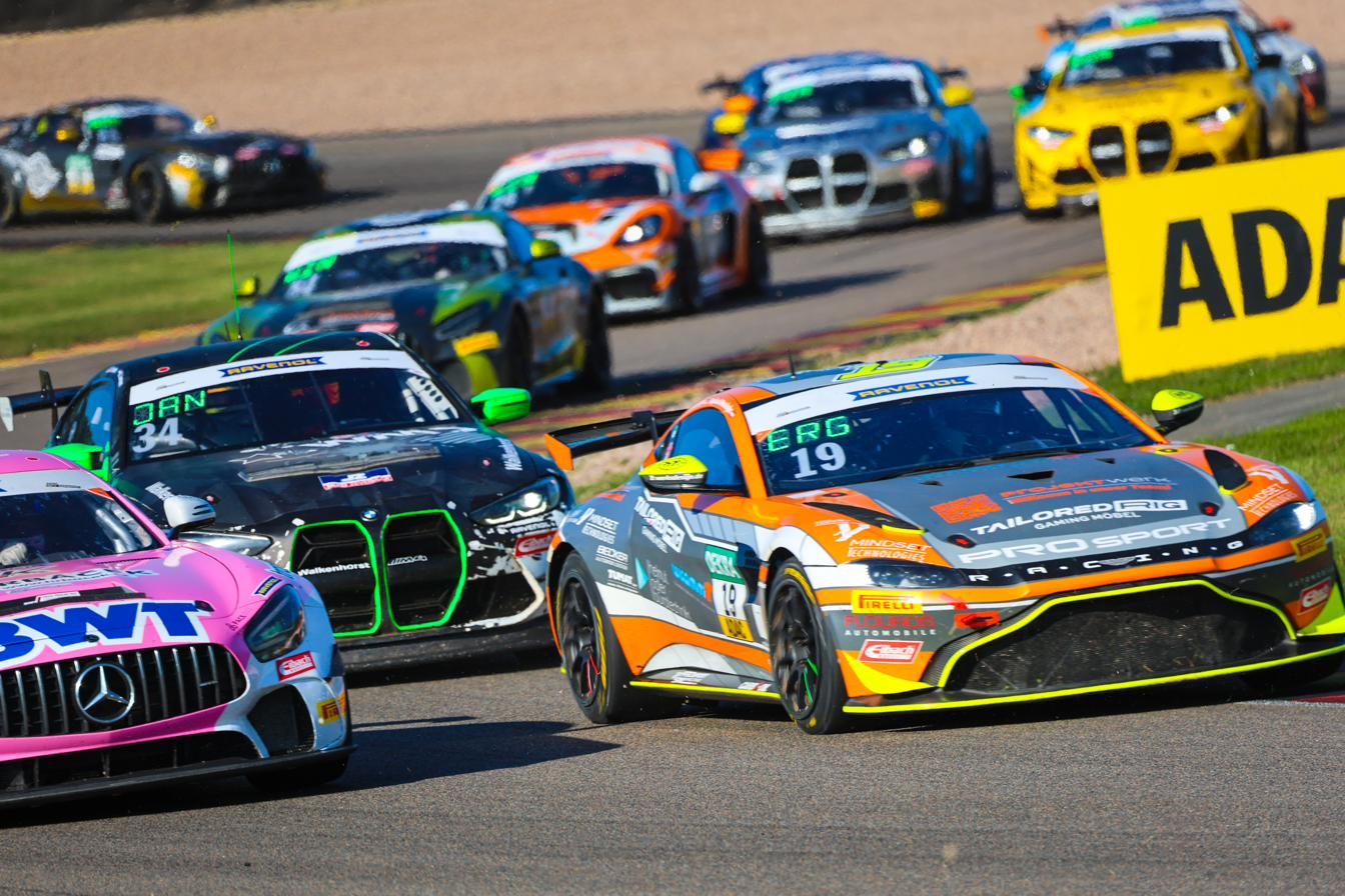 GT4 field battling wheel to wheel, the number 19 Aston Martin at the front